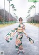 A woman in a kimono is walking down the street.