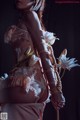 A woman in lingerie holding a bunch of flowers.