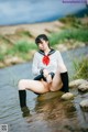 A woman in a school uniform is sitting in the water.