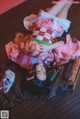 A woman in a pink kimono laying on the floor.