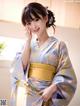 A woman in a blue and yellow kimono posing for a picture.